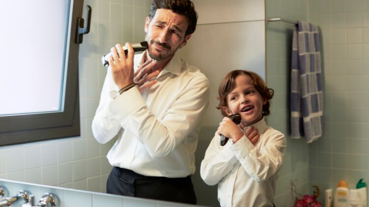 reflection of father and son shaving together