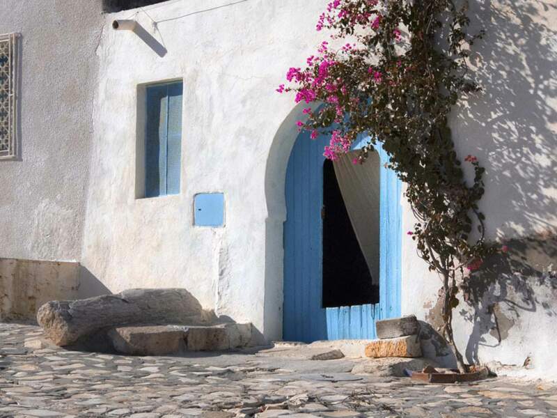 Une porte ouverte dans une ruelle calme à Hergla, gouvernorat de Sousse, en Tunisie