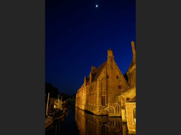 Les illuminations mettent en valeur les bâtiments le long des canaux de Bruges, en Belgique.