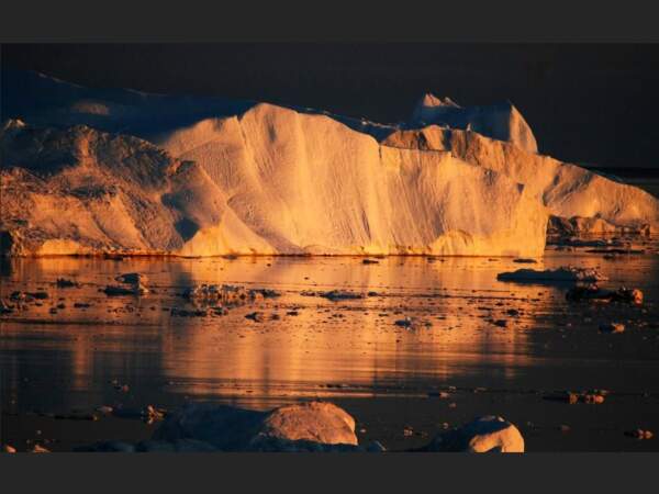 Iceberg éclairé par la lumière du soleil couchant dans la baie de Disko, au Groenland.